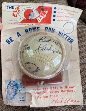 A baseball toy with Hank Aaron's signature.