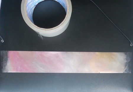 A colorful bookmark made from adhesive tape.