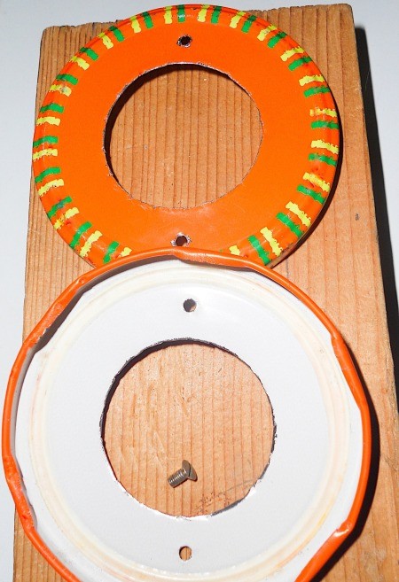 Two painted metal lids for a terrarium.