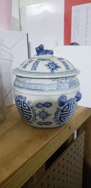 A small china pot with a lid.