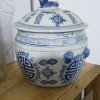 A small china pot with a lid.