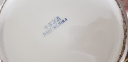 The marking on the bottom of the china pot.
