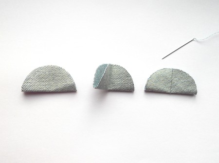 Folding the circles and sewing them in half down the center.