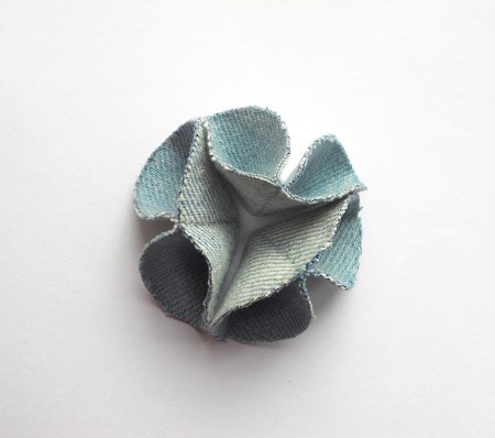 Attaching the three folded circles together.