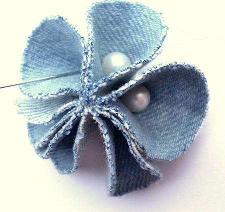 Adding beads in the center of each petal.