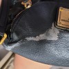 A bleach stain on a leather purse.