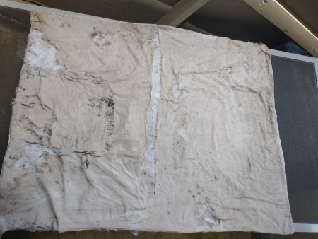 A blanket that has been left outside in the weather.