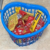 A basket of fast food condiment packets.