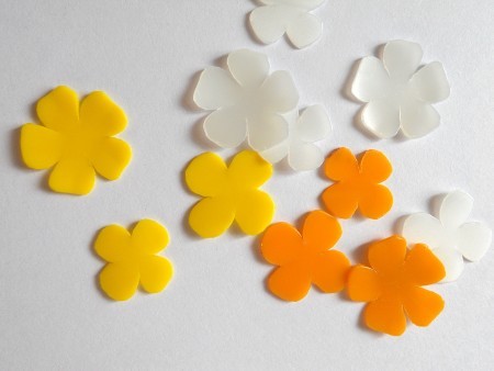 A collection of flower shapes cut out of plastic.