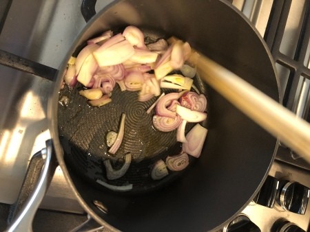 Sautéing onions in a pan.