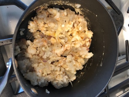 Adding the shrimp to the onion mixture.