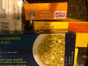 Boxes of noodles in a pantry.