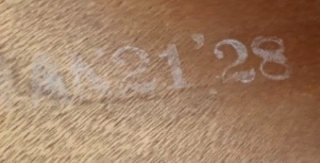The date on the back of a wooden desk.