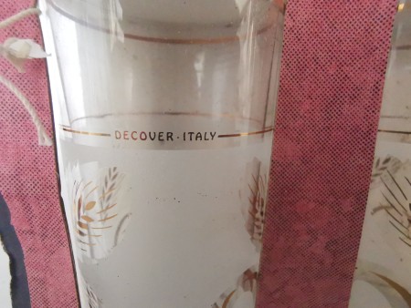 The back of a decorative glass that says "DECOVER ITALY"