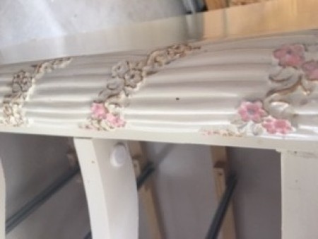 Adding color to the decorative flowers on the side of the dresser.