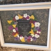 A wedding announcement surrounded by dried flowers.