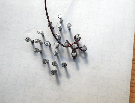 Weaving wire around the nails.