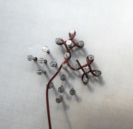 Weaving wire around the nails.