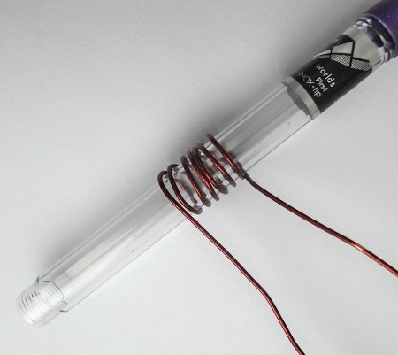 Wrapping wire around a pen.