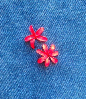 Painted wire flowers attached to denim.