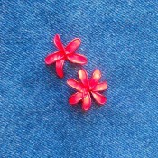 Painted wire flowers attached to denim.