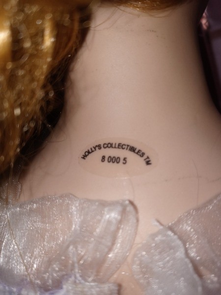 The marking on the back of a porcelain doll.