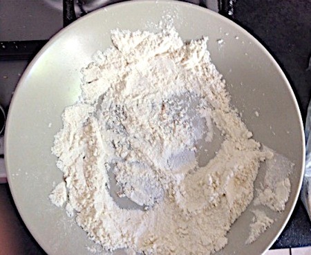 A dish of flour to coat the oxtails.