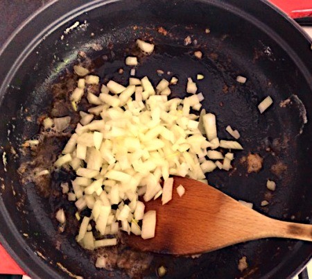 Browning onions in a pan.