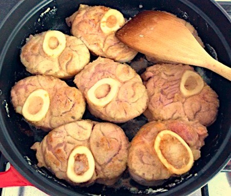 Flipping the browned veal.