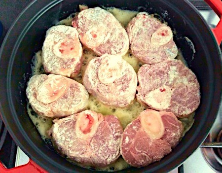 Browning the veal in a large pot.