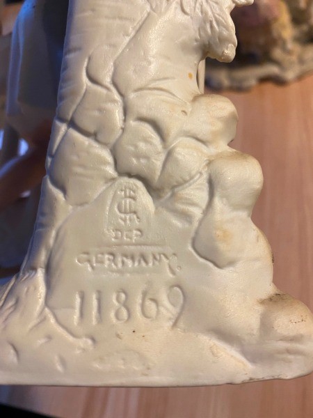 Markings on the back of a decorative figurine.