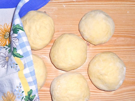 Dividing the dough into smaller balls.