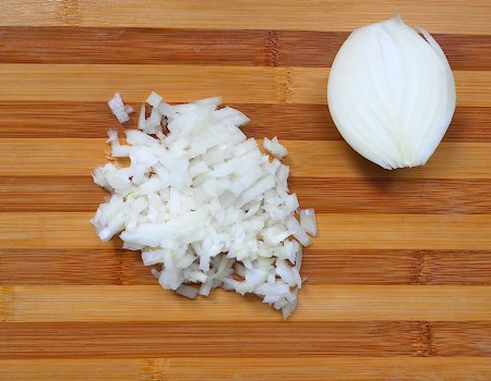 Dicing a white onion.