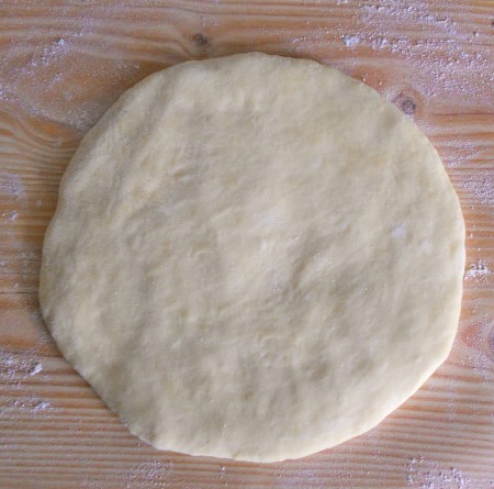 Flattening the dough into a circle.