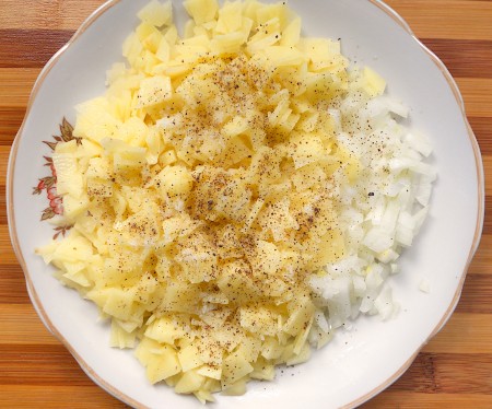 Mixing the onion and potato filling.