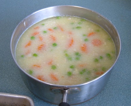 Combining the filling for the chicken pot pie.
