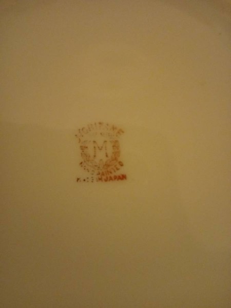 A maker's stamp on the back of a china teapot.