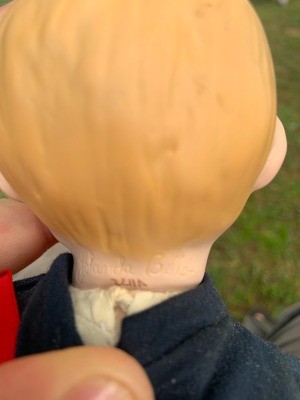 The marking on the back of a doll's head.