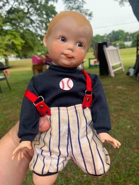 A porcelain doll dressed as a baseball player.