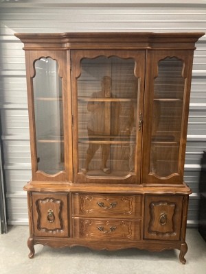 A tall wooden china cabinet.