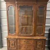 A tall wooden china cabinet.