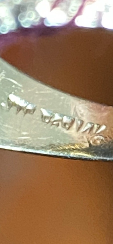 Writing inside a gold ring.