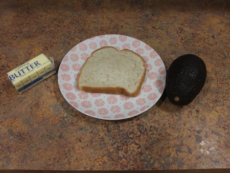 Bread, butter and avocado to make avocado toast.