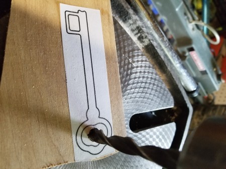 Drilling out the center of the key shape.