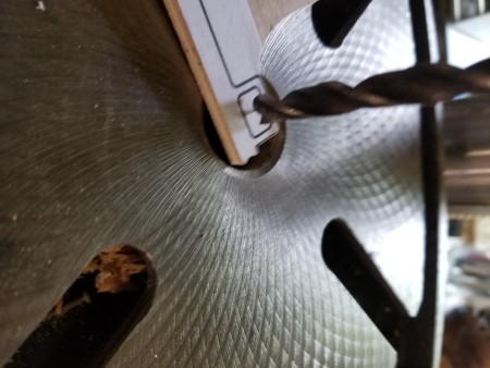 Drilling out the center of a key shape.