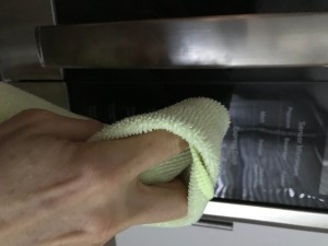 Using a cloth to avoid smudges on the microwaves.