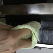 Using a cloth to avoid smudges on the microwaves.