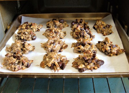 Placing the cookies on a cookie sheet in the oven.