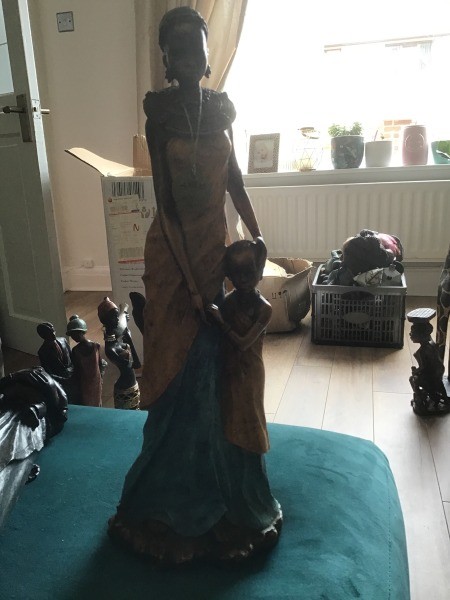 A figurine of a woman with a child standing next to her.