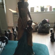 A figurine of a woman with a child standing next to her.